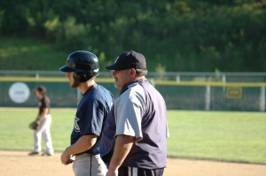 Coach talking with Justin Fink on first base