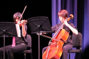 Sophomore Teyva Chee (left) and junior Caitlin Tsai (right) play together in the first of three string quartets.
