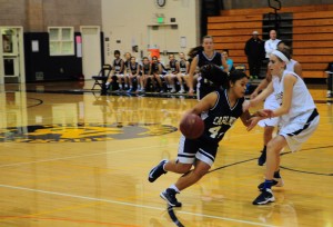 Sophomore Vianka Adamovitch dribbles around her opponent, trying to shoot a basket for Carlmont.