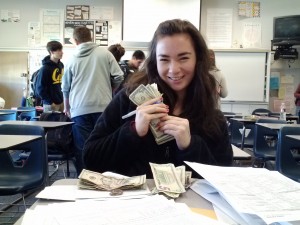 Junior Leah Roe counts the money submitted for second semester members.