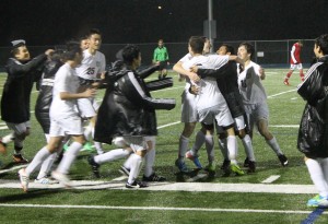  Boys Varsity Soccer runs on the field to congratulate junior Nathan Rosenthal for scoring the winning goal for Carlmont in double-overtime. 