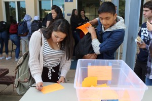 Juniors Kira Roman and Jared Gutierrez carefully decide who to vote for before turning in their ballot. 