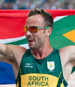 Runner Oscar Pistorius represents his country after a race. Image courtesy of Creative Commons Search.