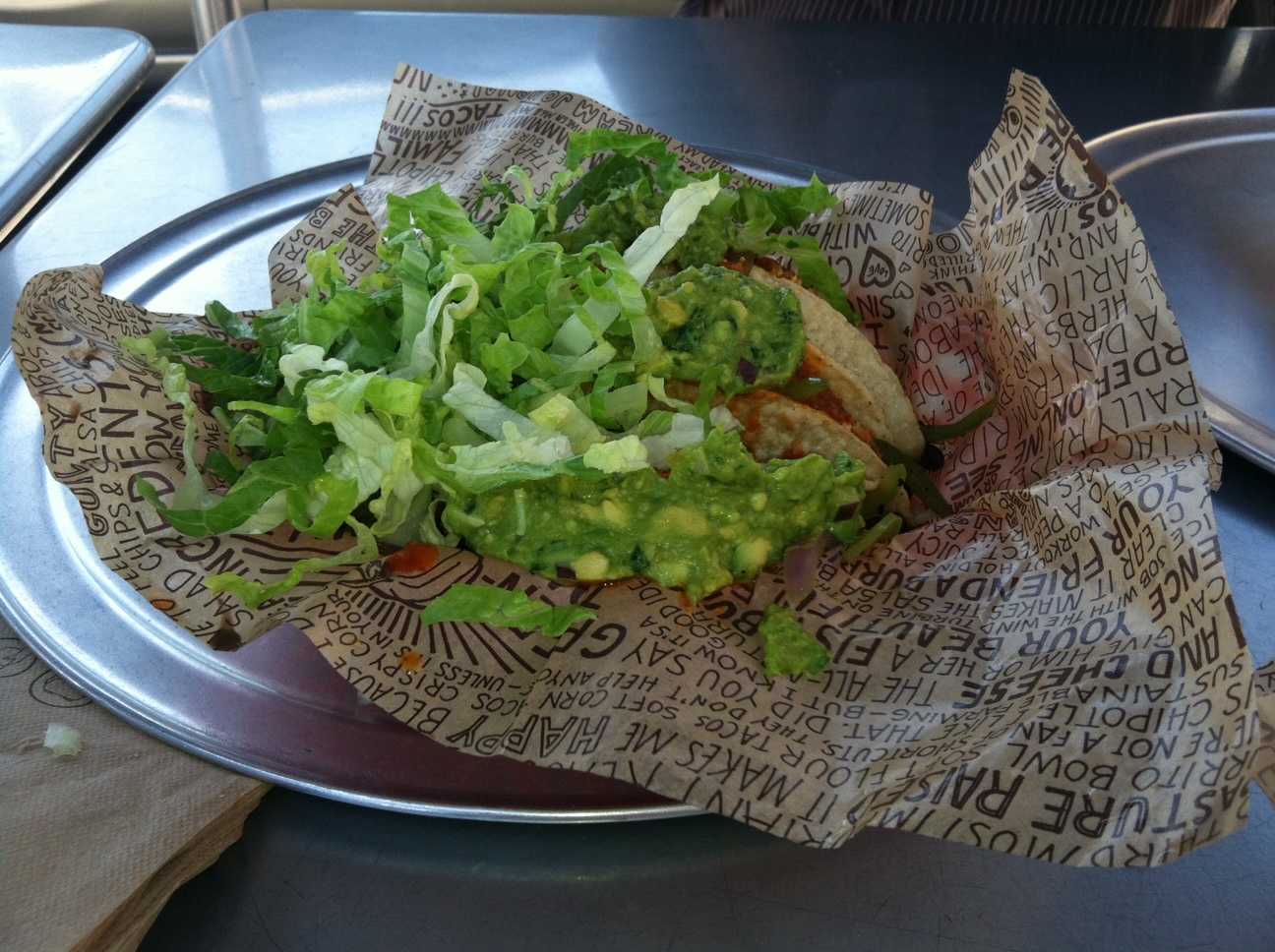 Three tacos hiding under guacamole