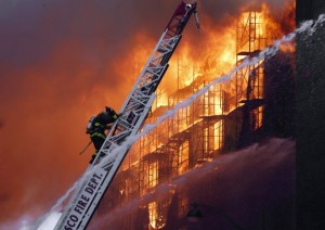 Firefighters work to extinguish the fire in the apartment building.